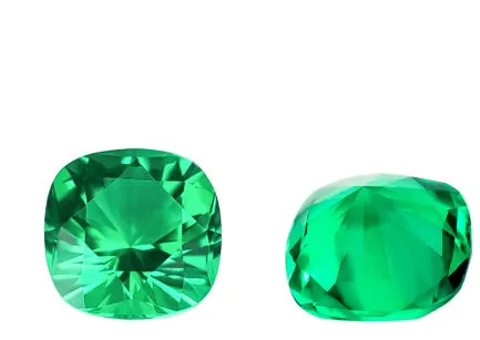 Cultivated emerald green treasure shaped colored gemstone round cut polished loose stone on white background
