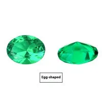 Cultivated emerald green treasure shaped colored gemstone round cut polished loose stone on white background