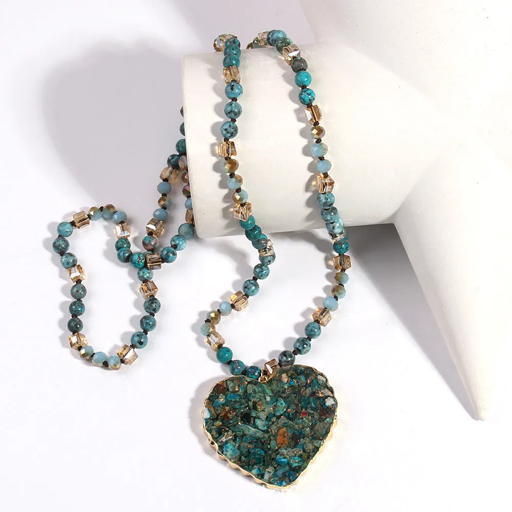 Bohemian style long chain heart pendant necklace in stone and glass with electroplated finish, available in multiple colours.