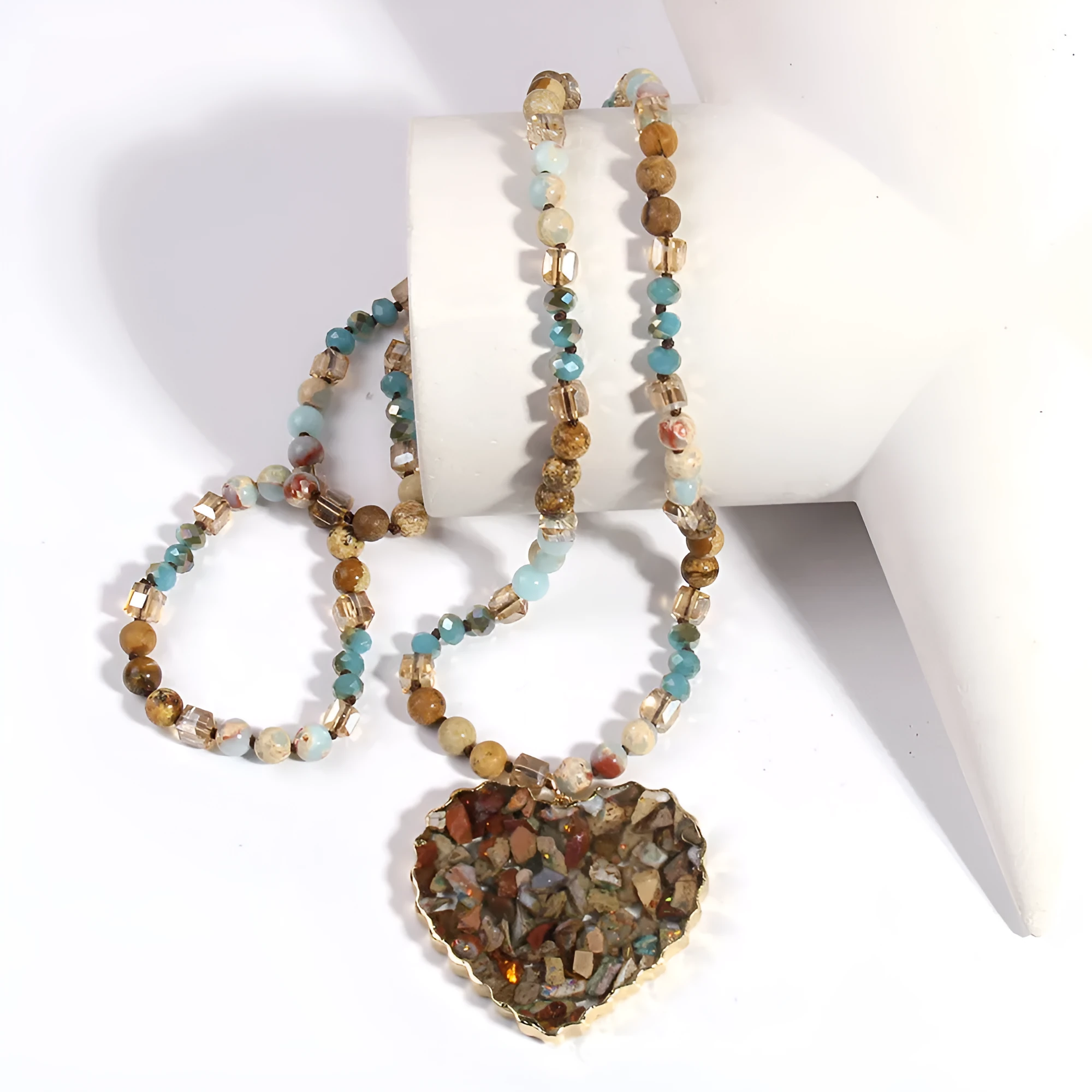 Bohemian style long chain heart pendant necklace in stone and glass with electroplated finish, available in multiple colours.