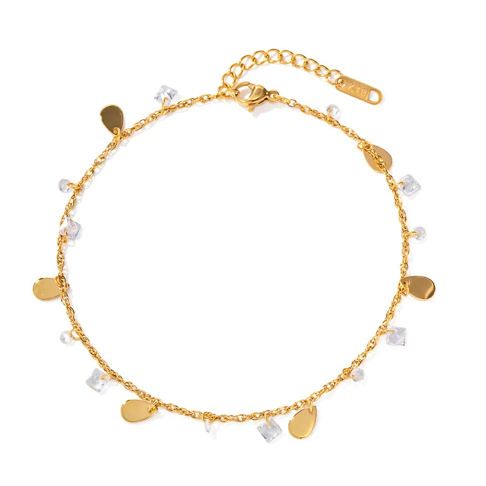 Stainless steel women's anklet with a geometric water drop tassel charm on an ankle.