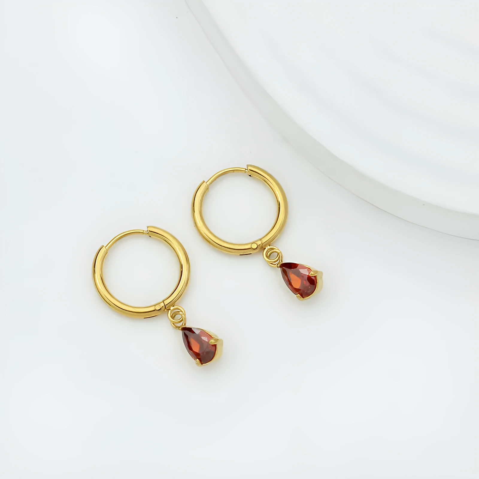 Drop-shaped zircon earrings in seven colours on a woman's earlobe titanium steel geometric design