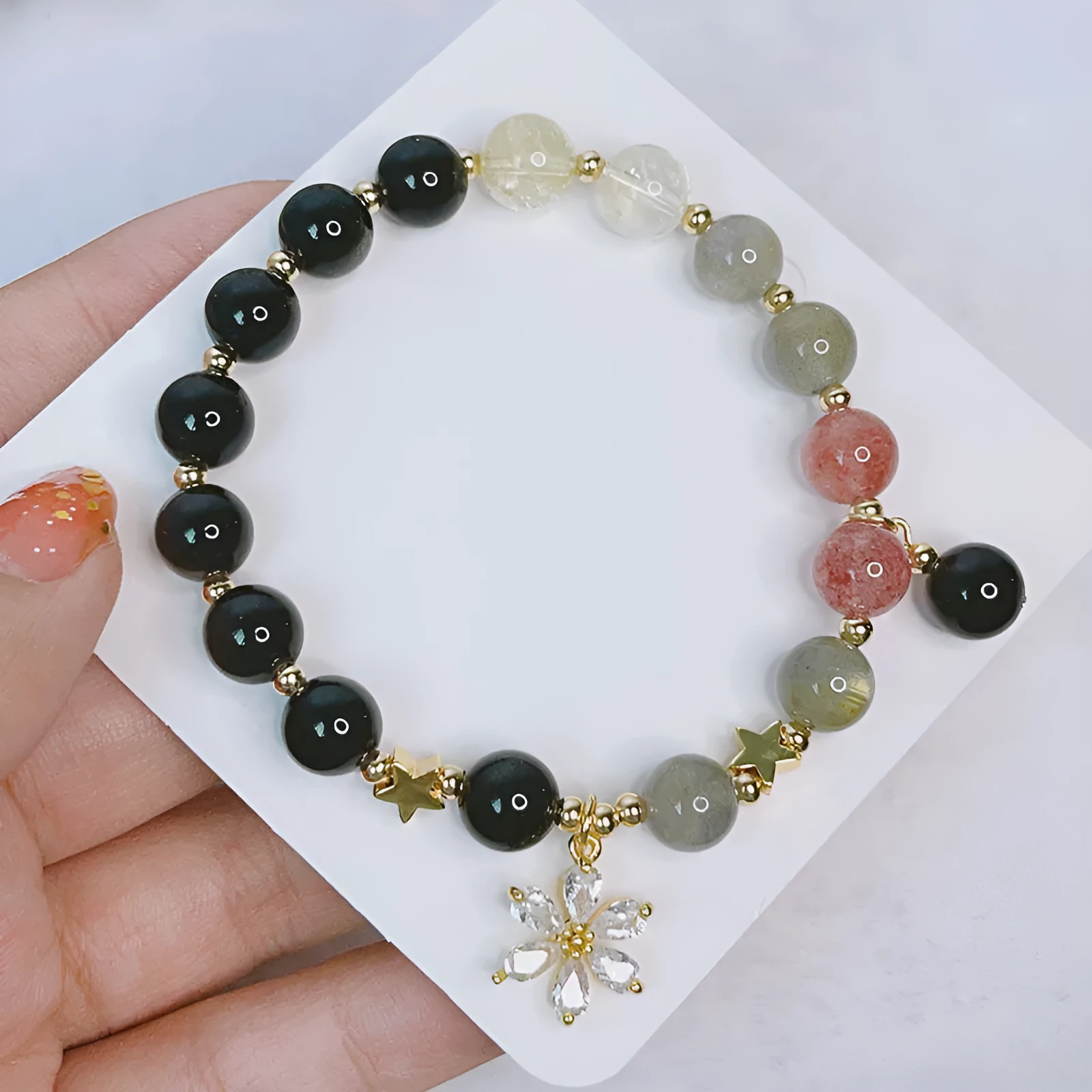 Women's silverstone charm bracelet with electroplated finish showing floral, heart, and star design options
