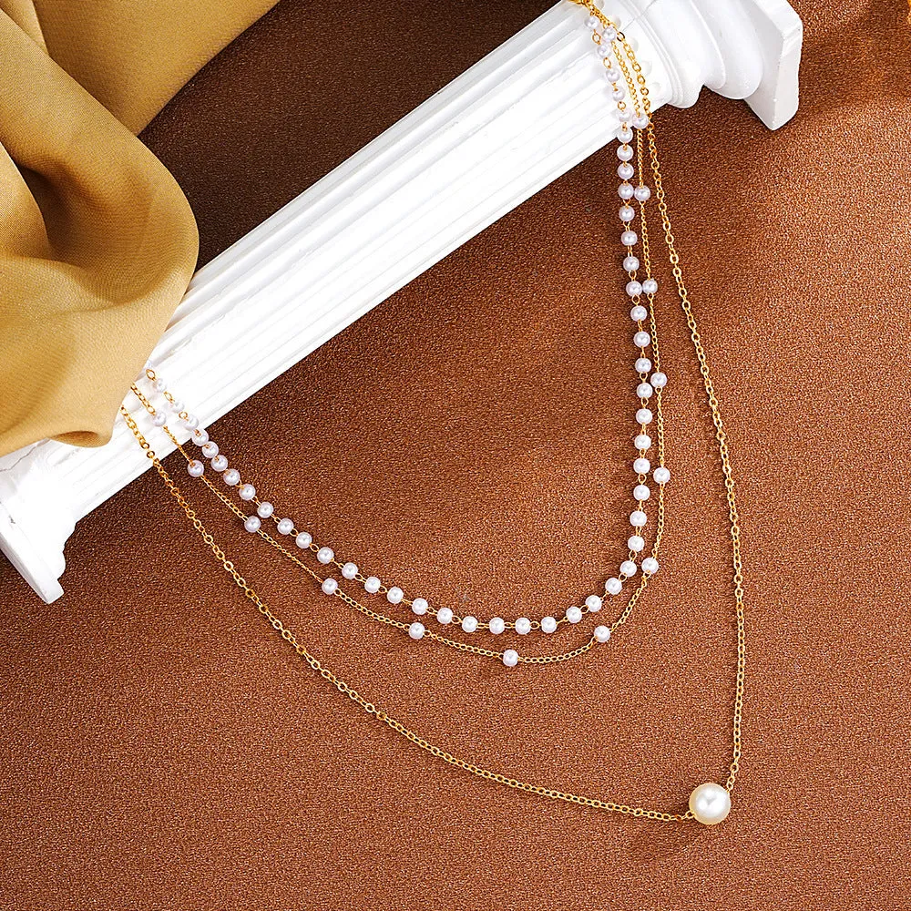 Three-layer gold imitation pearl necklace with twin pendant leaf U-shaped geometric design