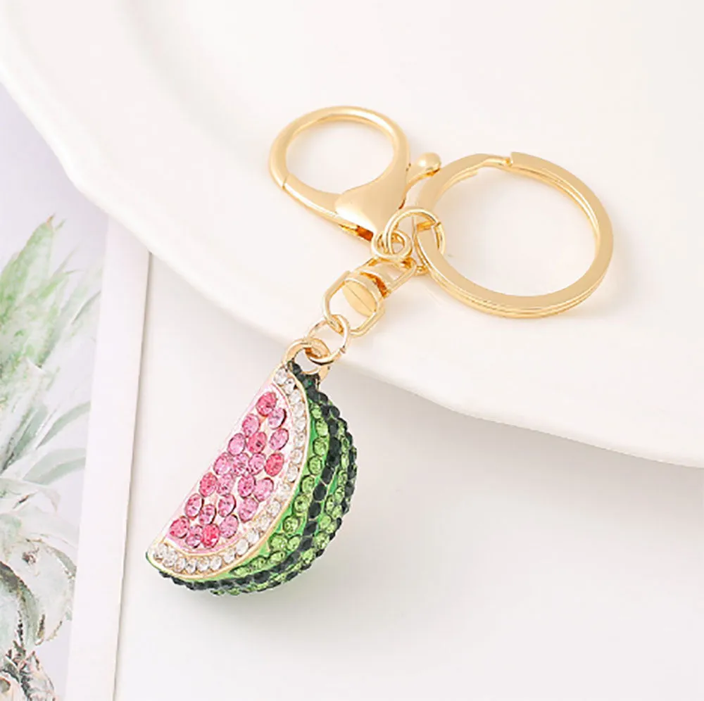 Creative watermelon shape metal car keychain in red on a white background