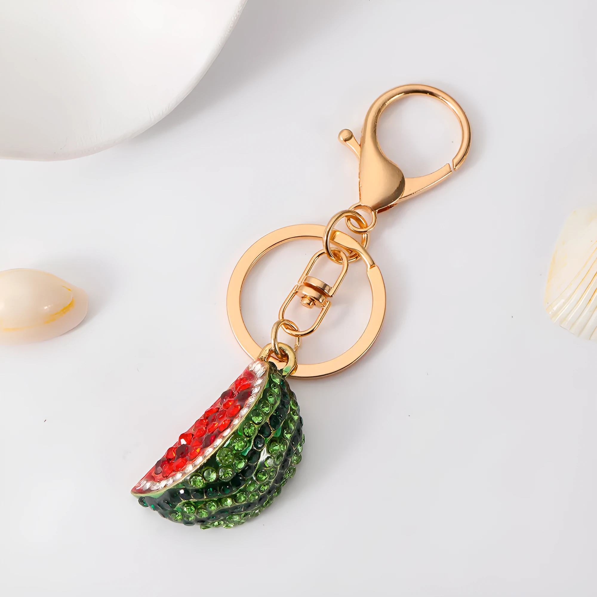 Creative watermelon shape metal car keychain in red on a white background