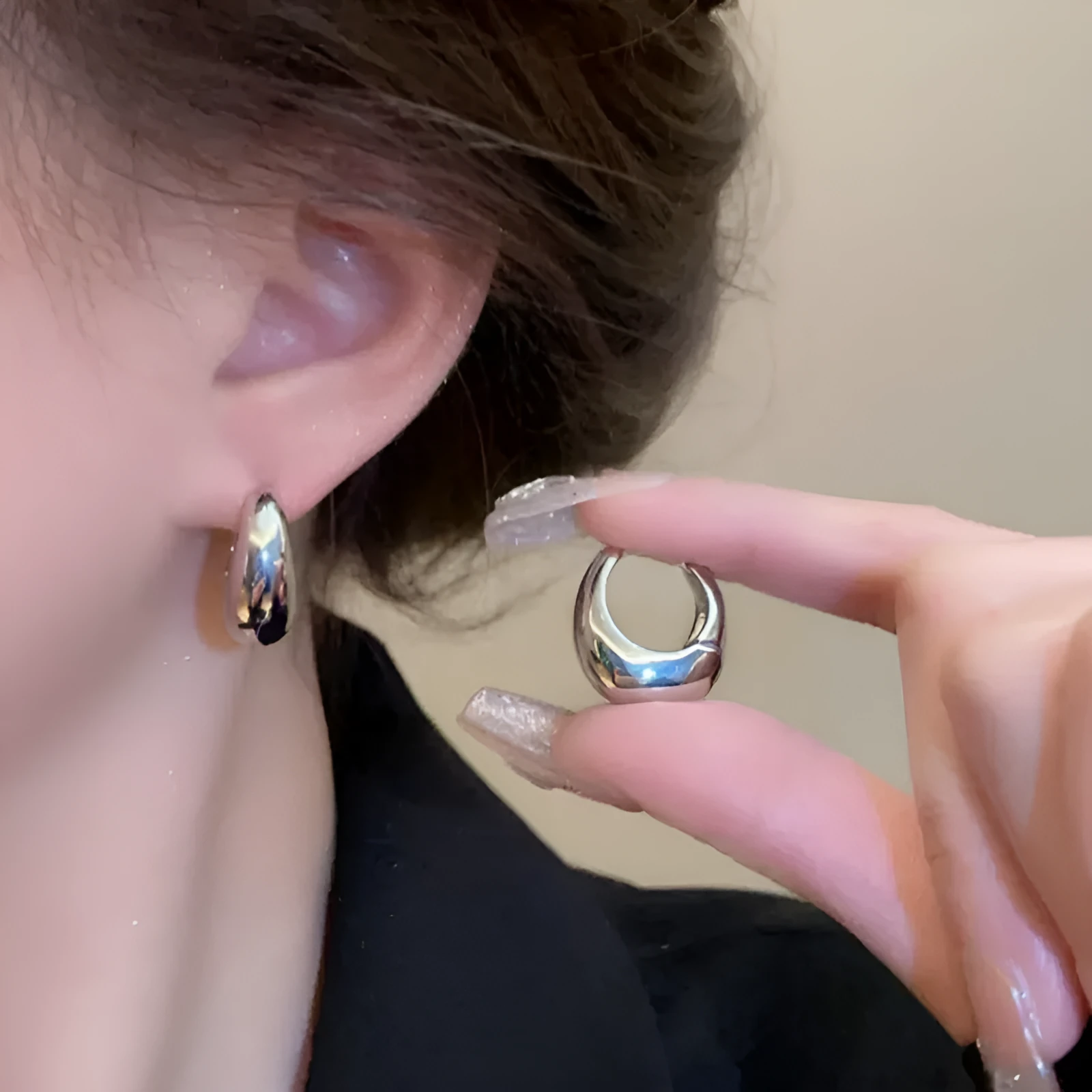 Pair of simple retro geometric alloy earrings in gold electroplated finish on a light background