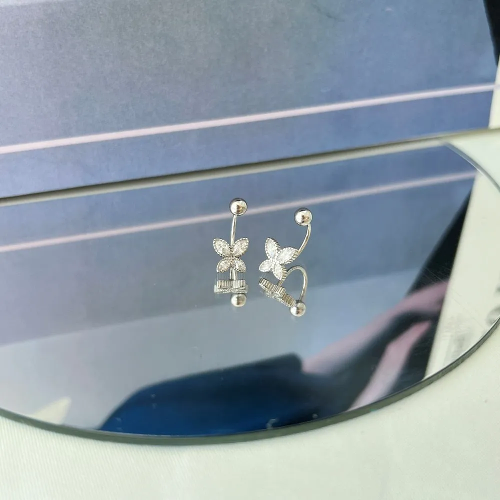 Pair of S925 silver bow-shaped ear hook earrings in gold finish on simple background