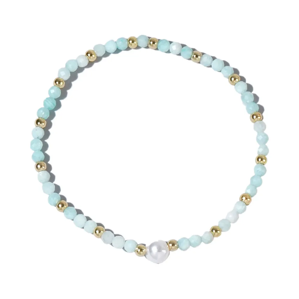 A unisex natural stone bracelet with elliptical geometric beads on a wrist, shown in one of the multiple available colours.