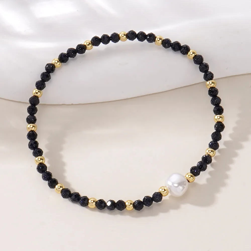 A unisex natural stone bracelet with elliptical geometric beads on a wrist, shown in one of the multiple available colours.