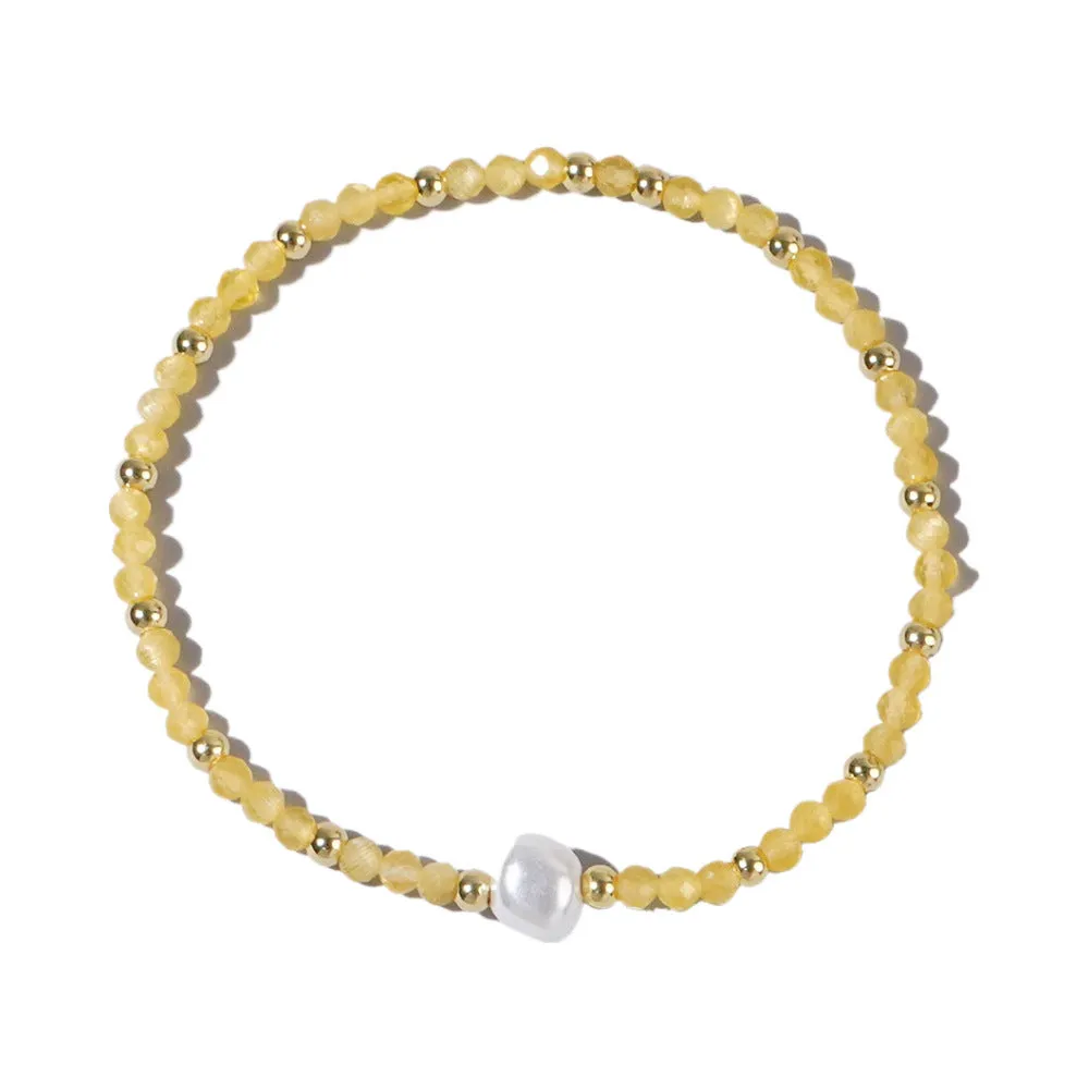 A unisex natural stone bracelet with elliptical geometric beads on a wrist, shown in one of the multiple available colours.