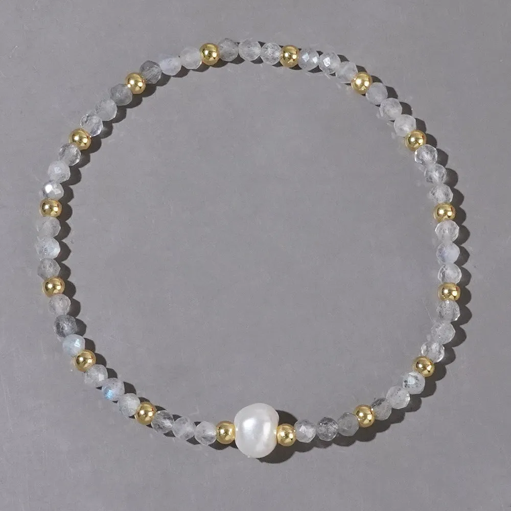 A unisex natural stone bracelet with elliptical geometric beads on a wrist, shown in one of the multiple available colours.