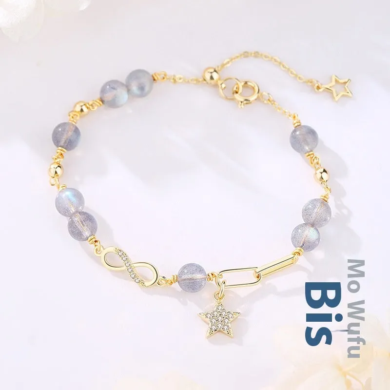 A women's adjustable Mobius crystal bracelet with a constellation design, showing the gray moonstone colour option.