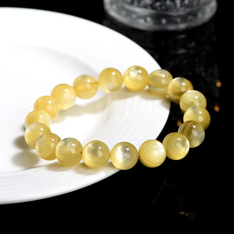 Yellow golden dragon mica bracelet with polished round geometric beads on wrist