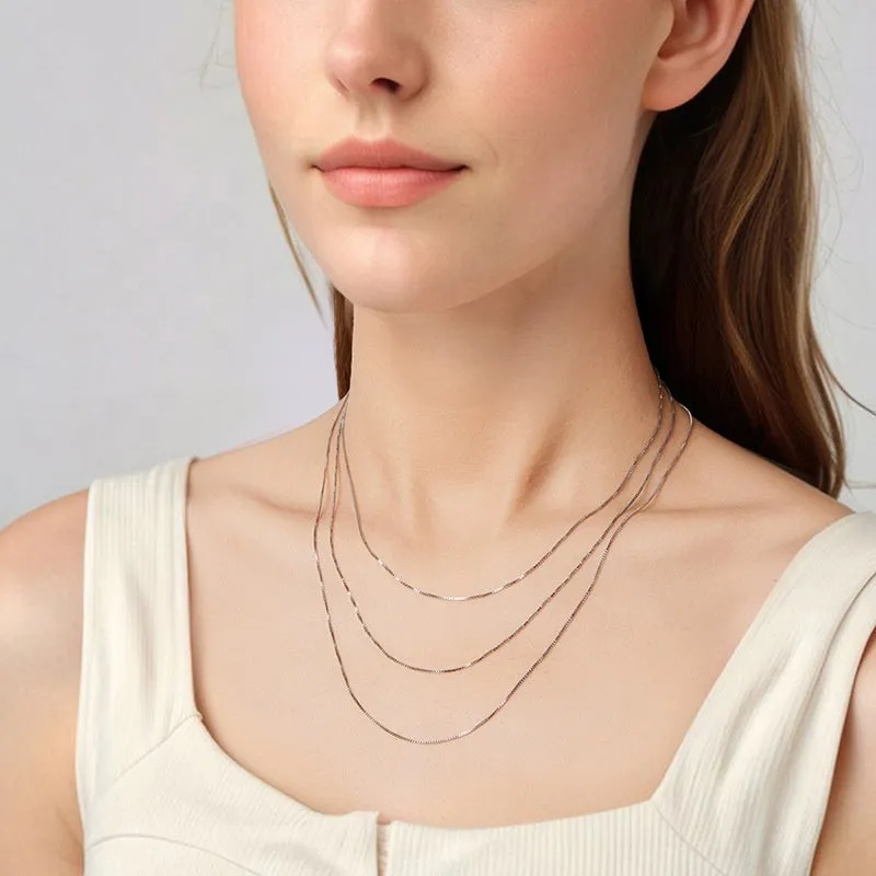 S925 sterling silver box chain necklace in silver colour, 40cm length on flat surface