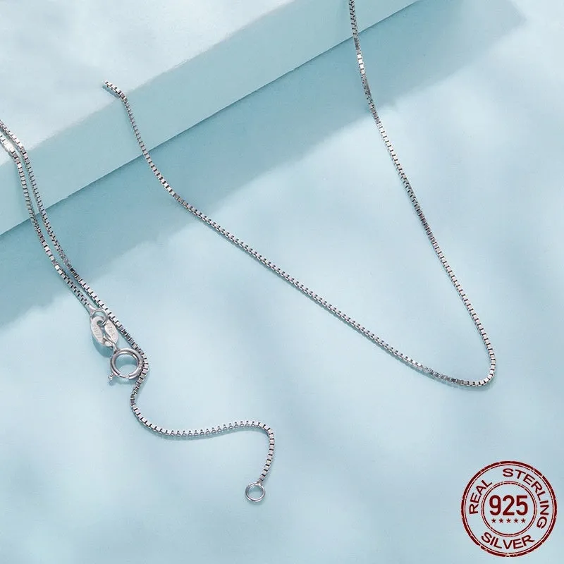 S925 sterling silver box chain necklace in silver colour, 40cm length on flat surface