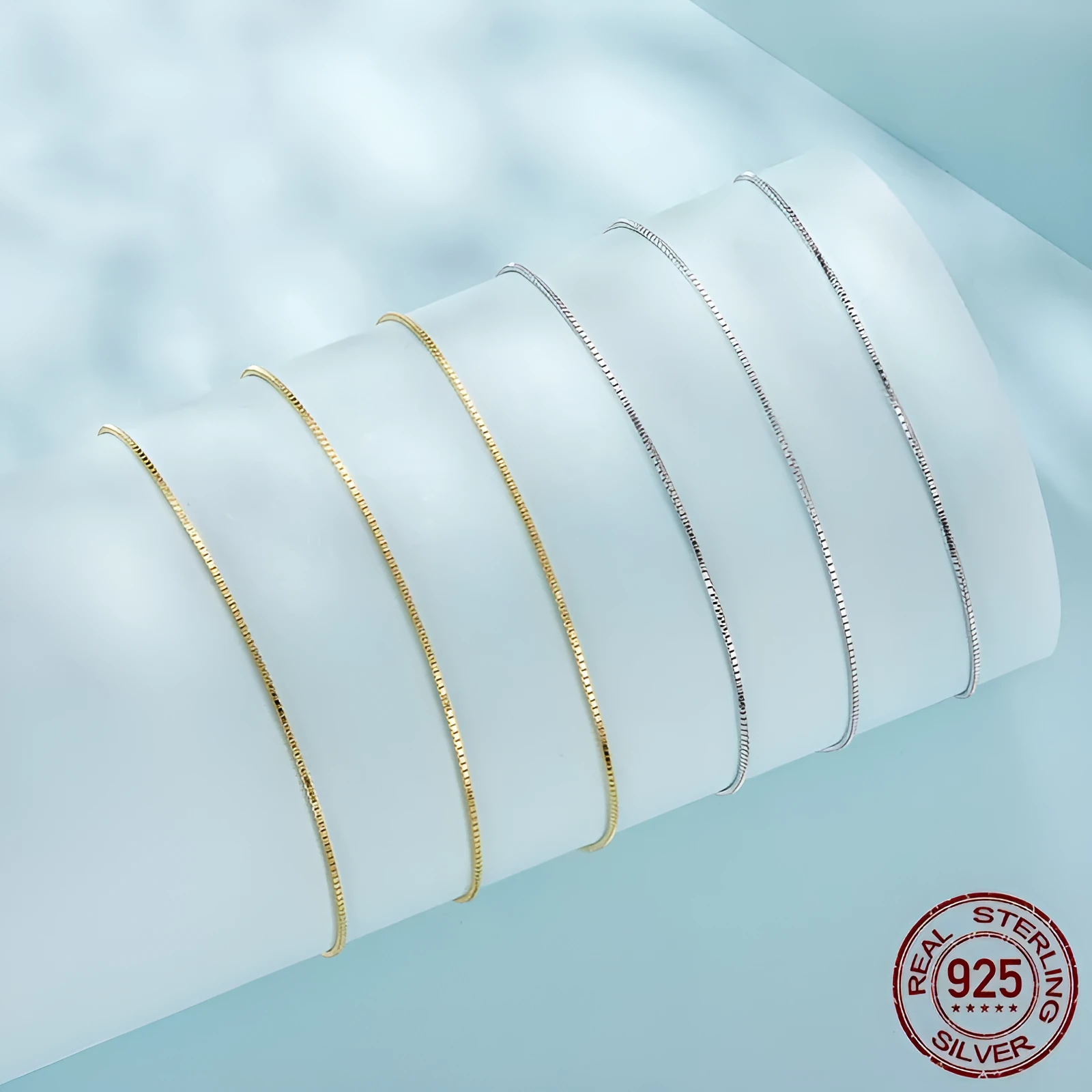 S925 sterling silver box chain necklace in silver colour, 40cm length on flat surface