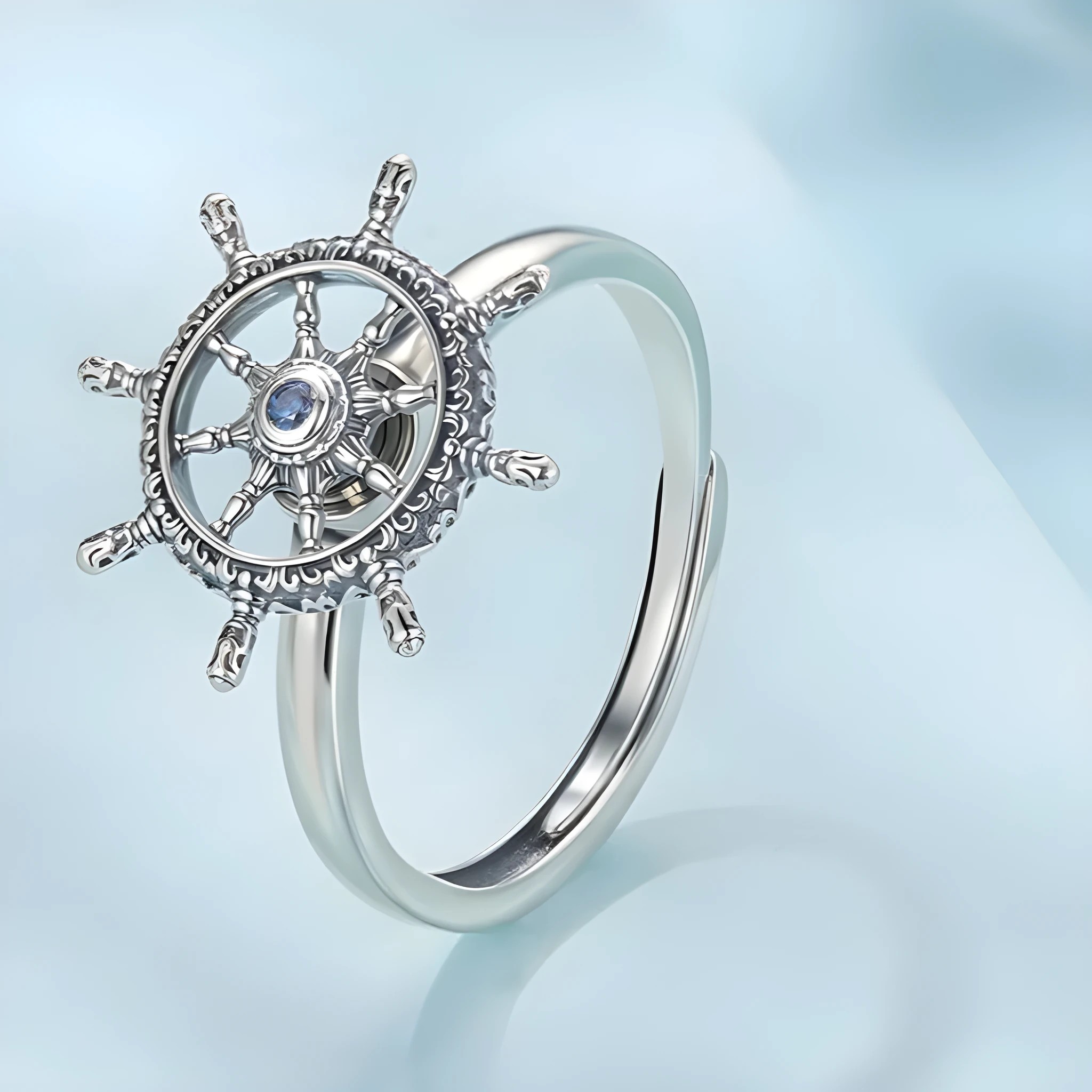 Retro women's silver ring with rotatable rudder design and inlaid zircon stone on open mouth band.