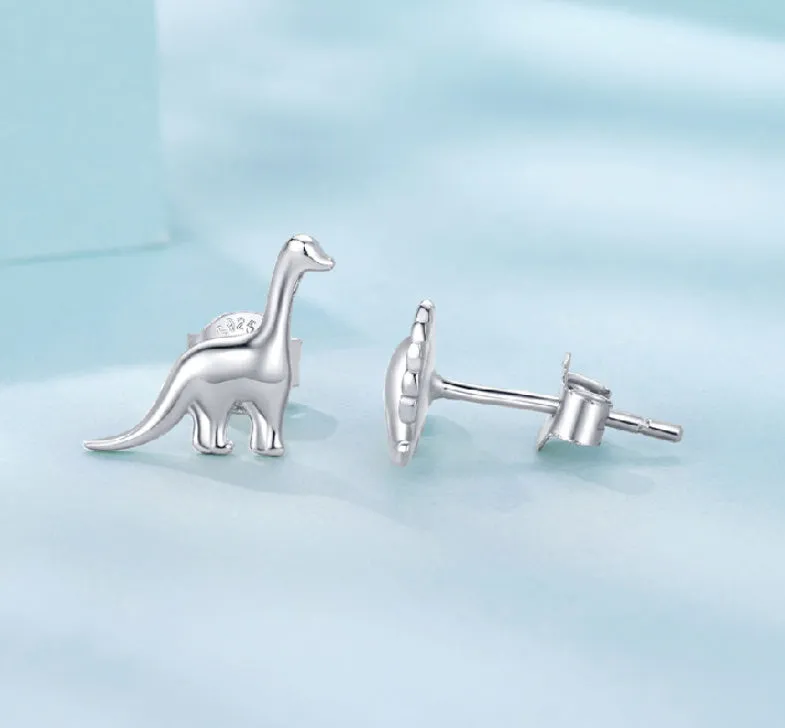 Asymmetric dinosaur stud earrings in 925 silver, animal element design, gold or silver colour option, on a neutral background