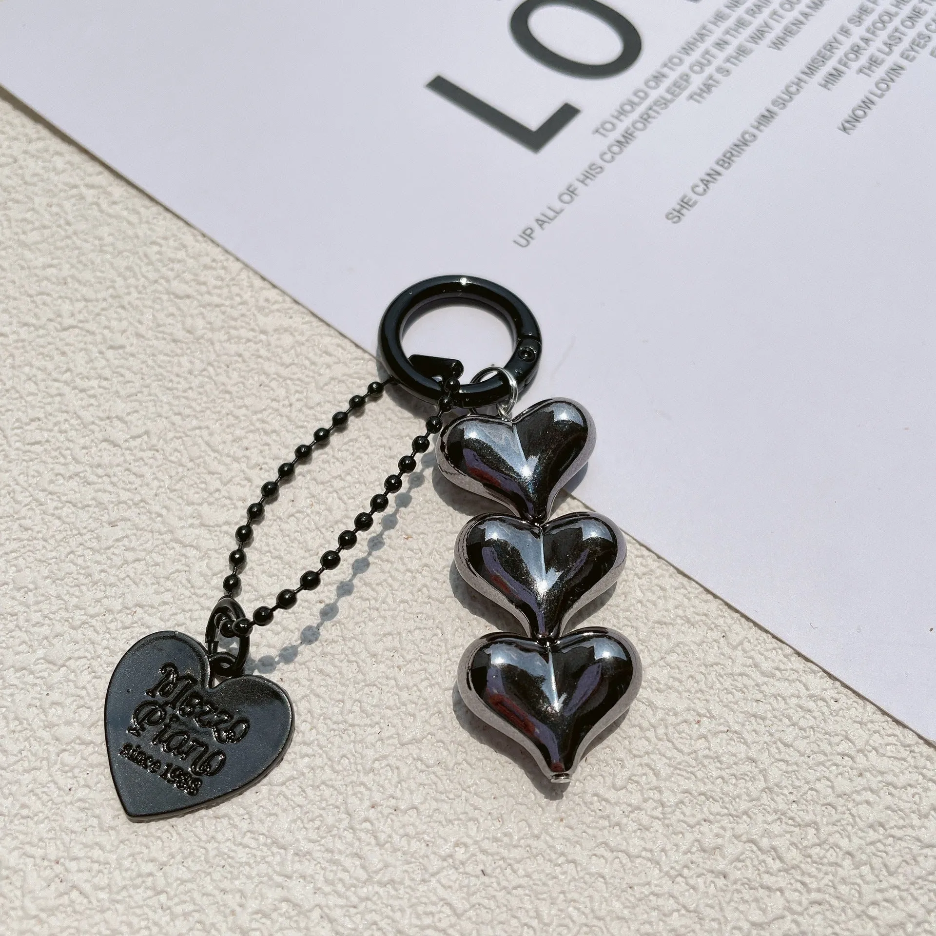 Love heart shaped acrylic charm keychain on an electroplated metal ring in silver finish.