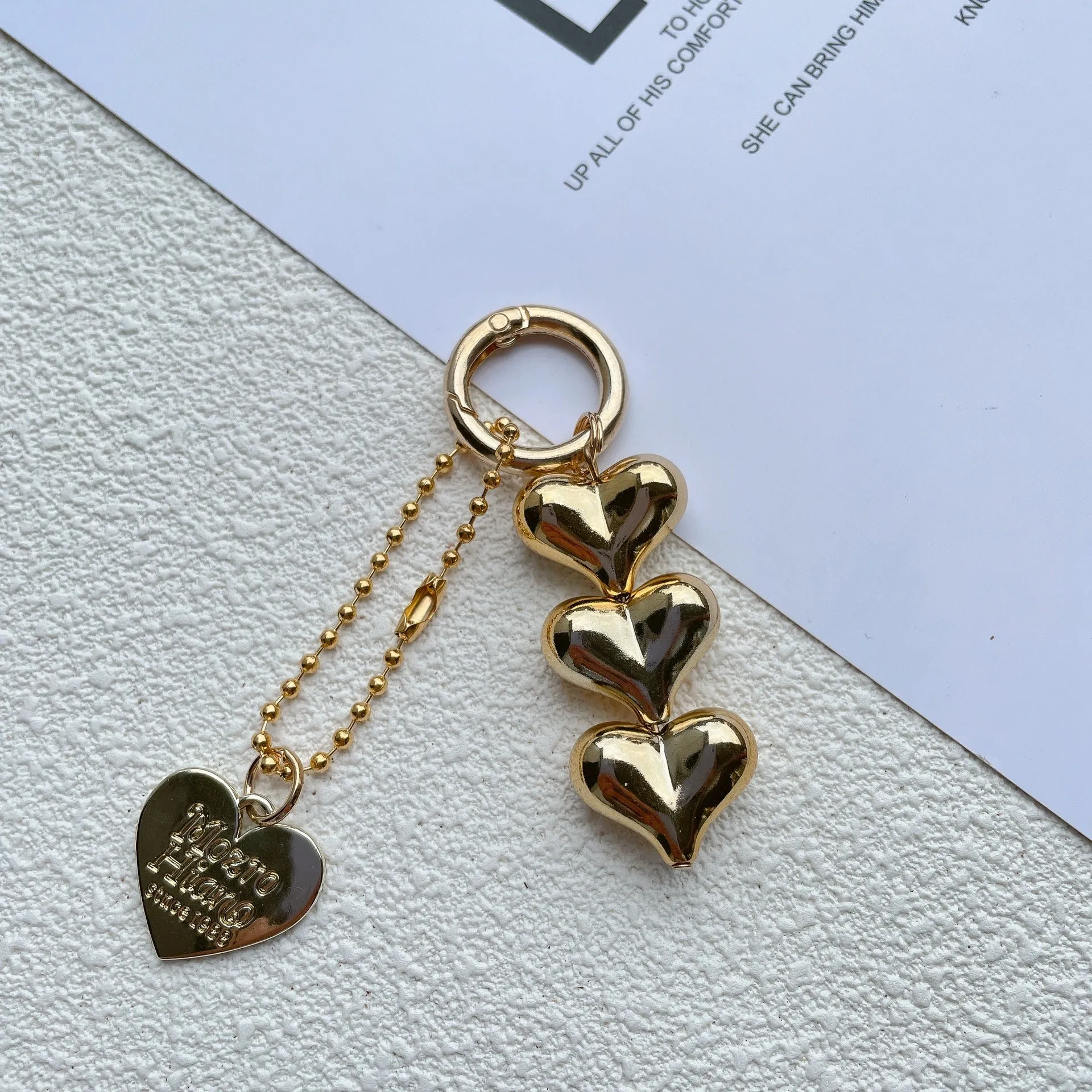 Love heart shaped acrylic charm keychain on an electroplated metal ring in silver finish.