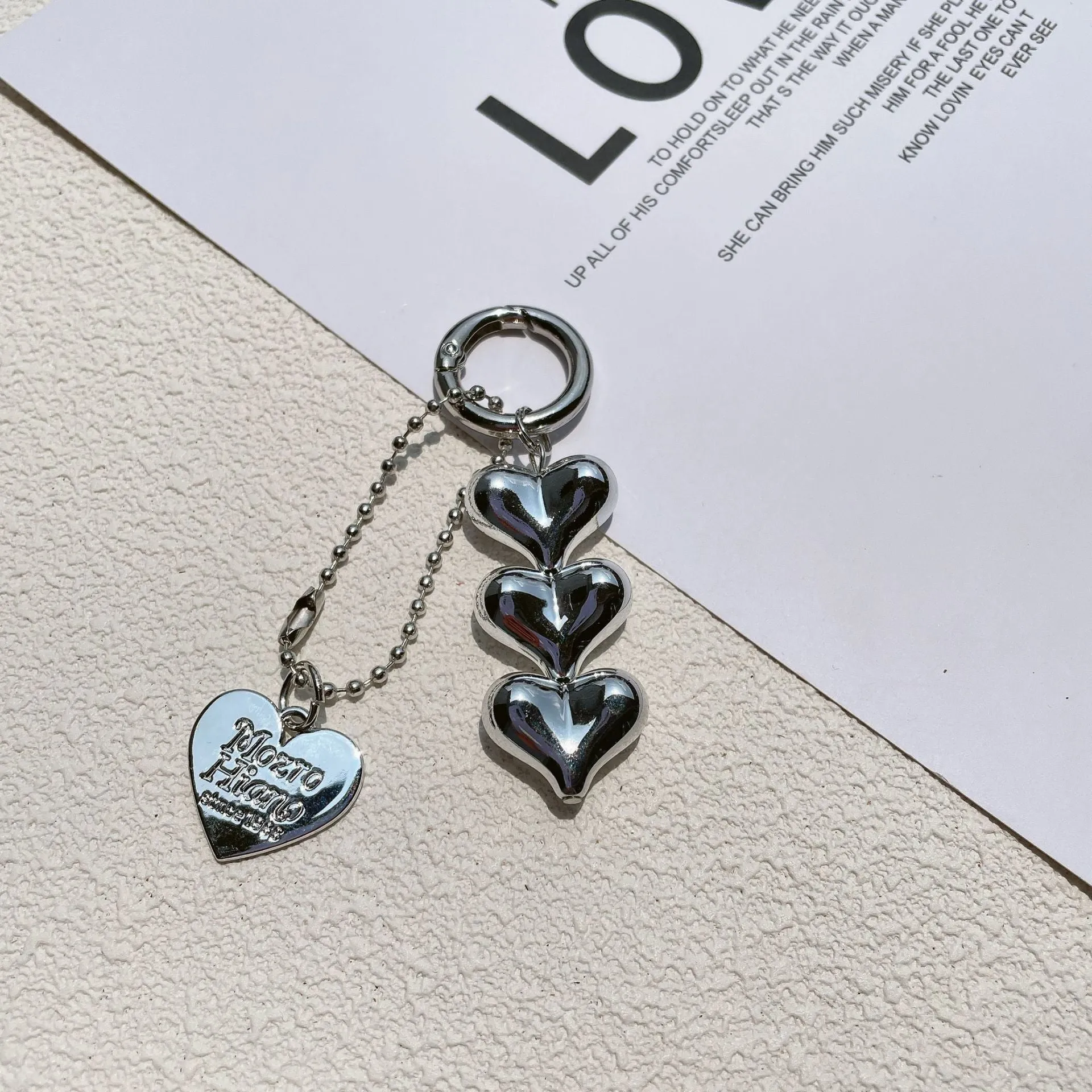 Love heart shaped acrylic charm keychain on an electroplated metal ring in silver finish.