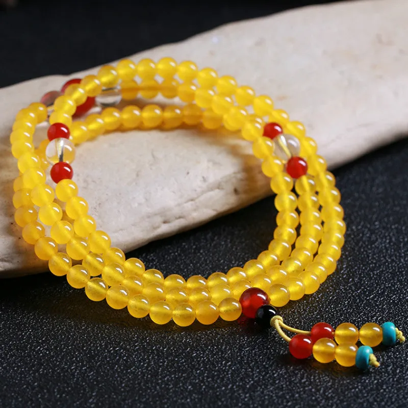 Women's geometric crystal necklace with lucky cat charm alongside 108 agate and canary stone beads