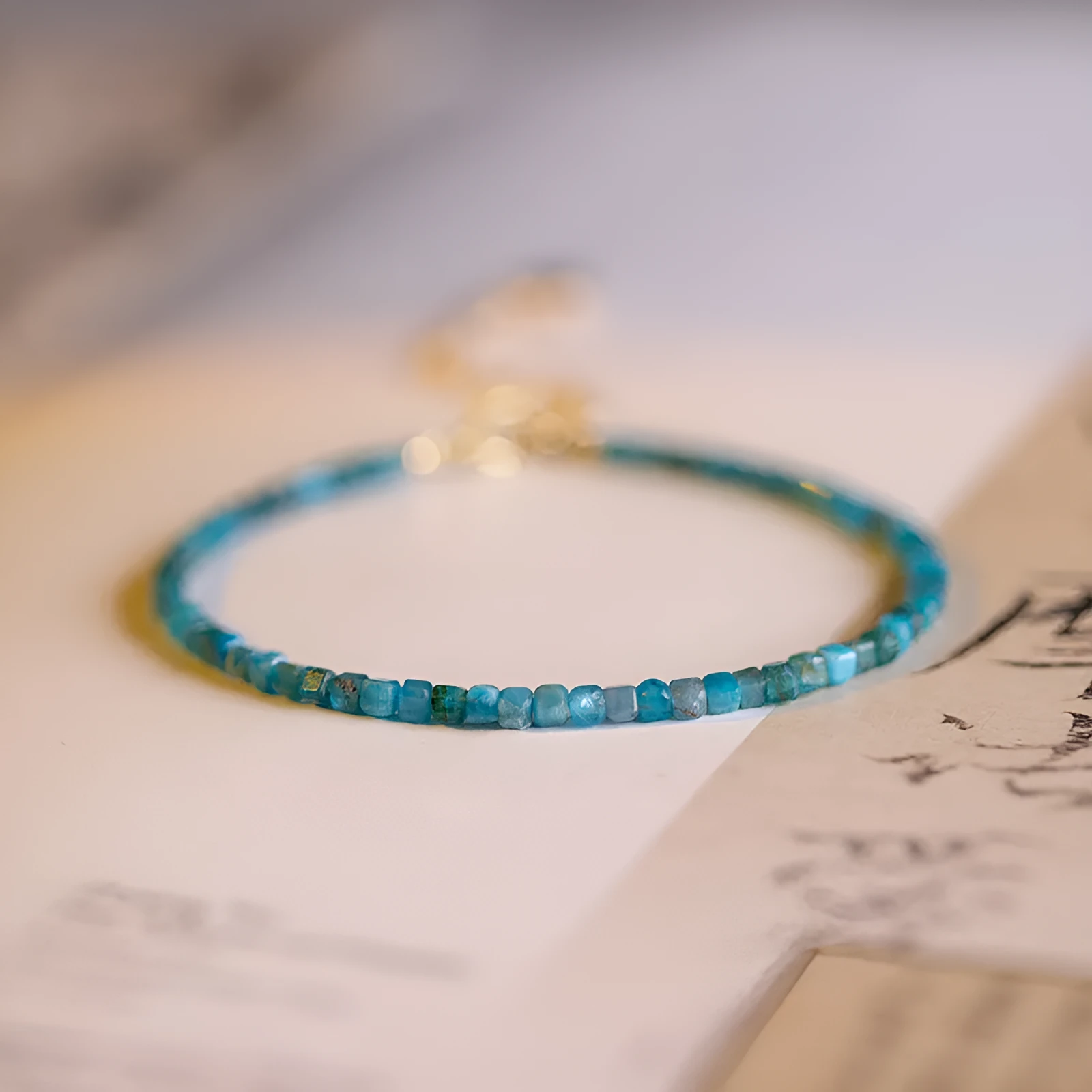 Women's natural blue apatite crystal bracelet with diamond-cut facets on adjustable band