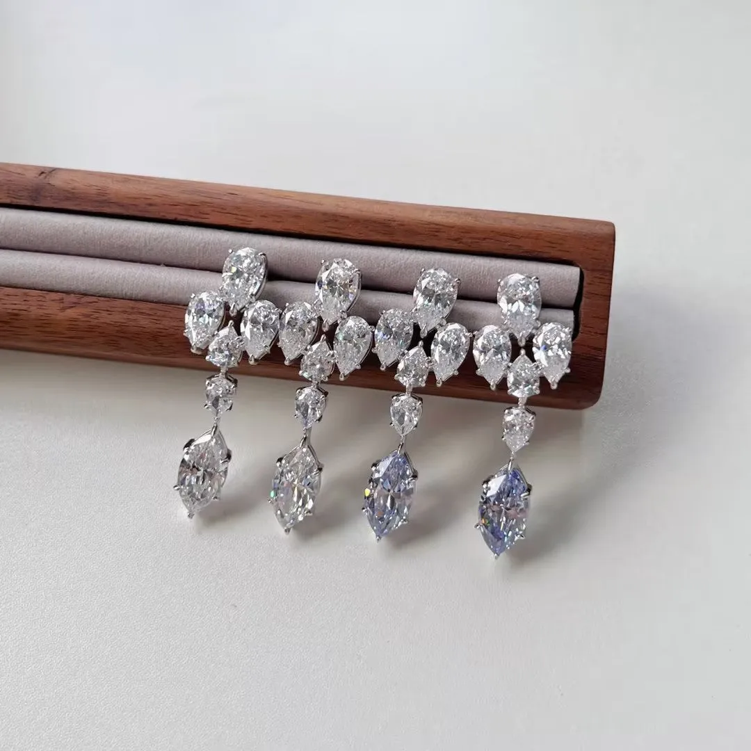 Pair of S925 sterling silver drop-shaped stud earrings with Platinum White Diamond electroplated finish on white background