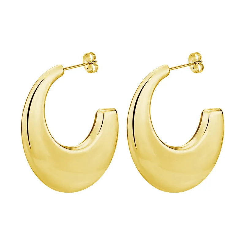 Two pairs of geometric thread stud earrings in gold and steel colour on a flat surface
