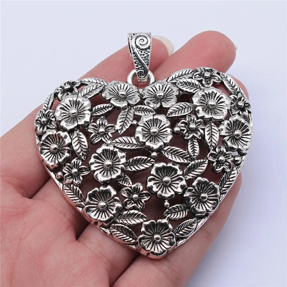 Ancient silver hollow flower love pendant measuring 67mm by 58mm with electroplated finish