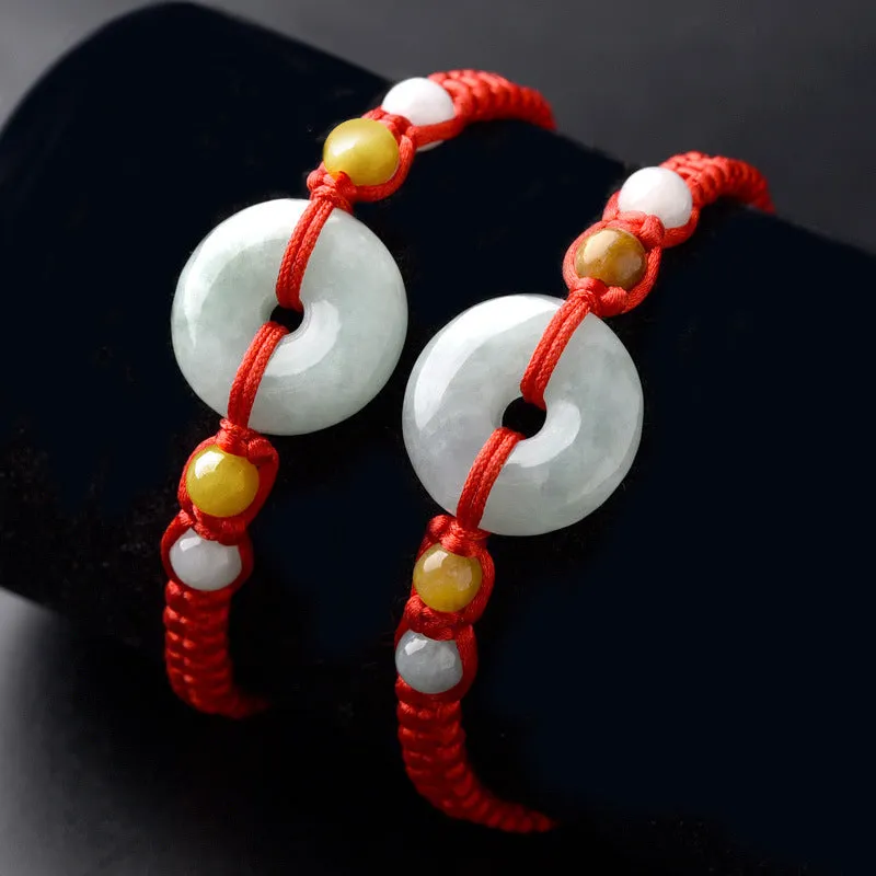 Round emerald green Burma jade pendant on an adjustable red rope bracelet strap.