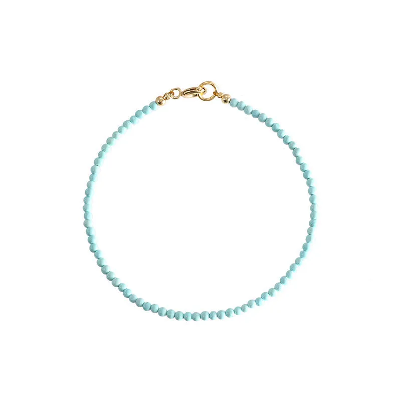 Close-up of a geometric bracelet made from small 2mm turquoise beads, shown in both raw and polished finishes, with a sizing chart for 14cm, 15cm, and 16cm wrists.