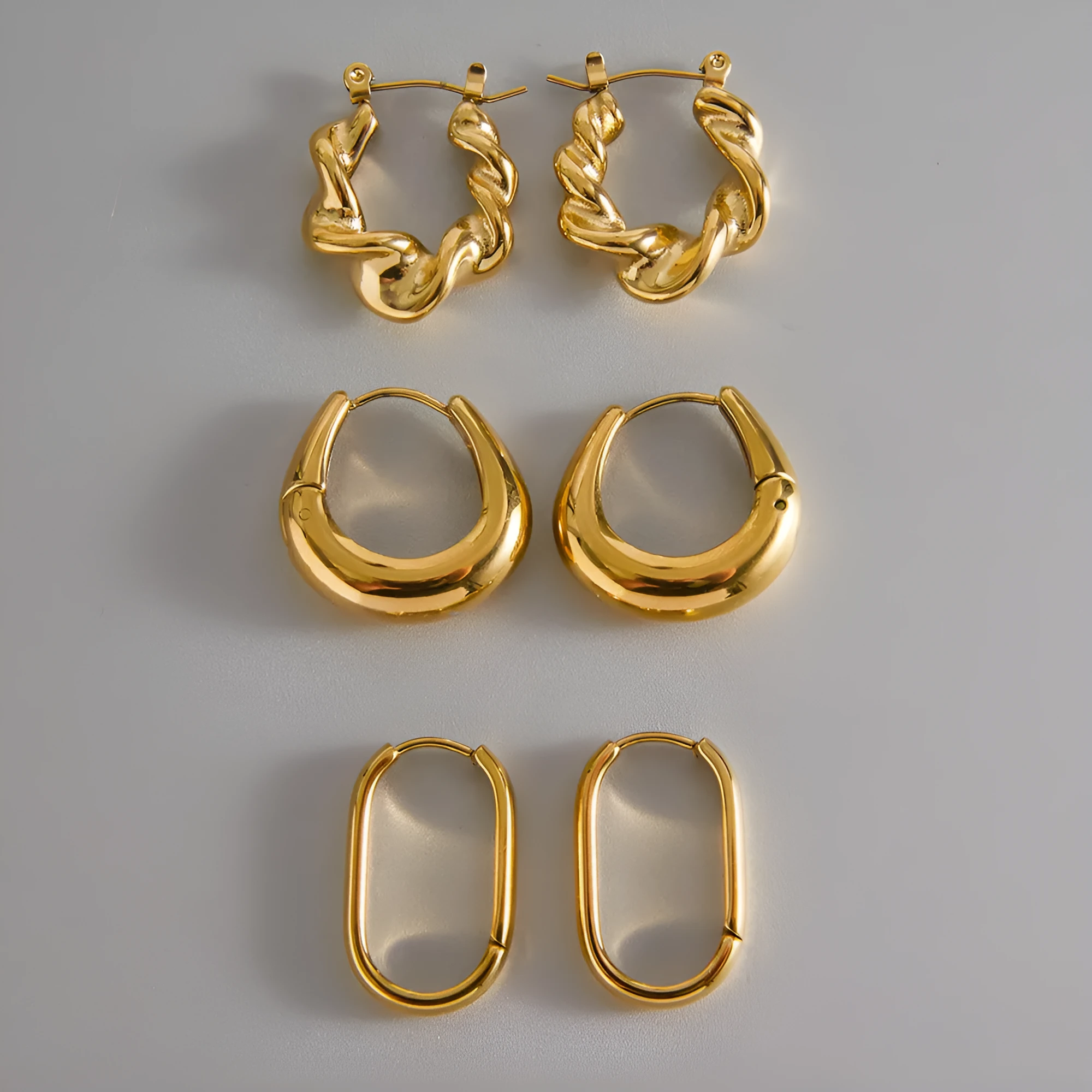 18K gold titanium steel geometric ellipse ear clip for women, light luxury style, on a model