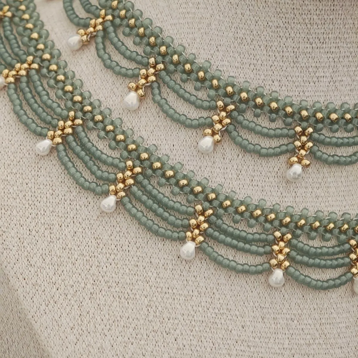 Retro style tassel water drop imitation pearl pendant necklace on display