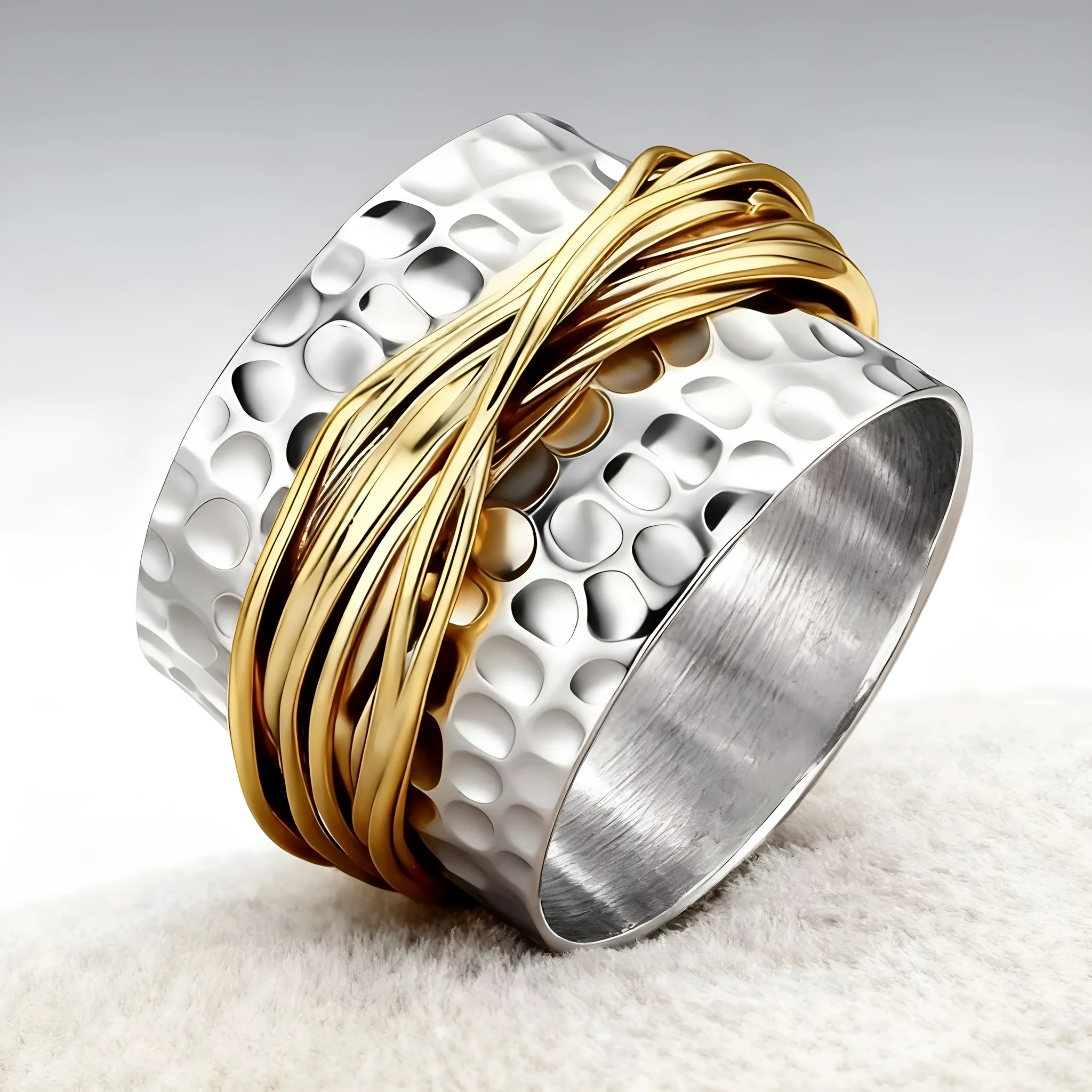 Alloy two-tone ring with hammered metal coil design, electroplated finish, on white background