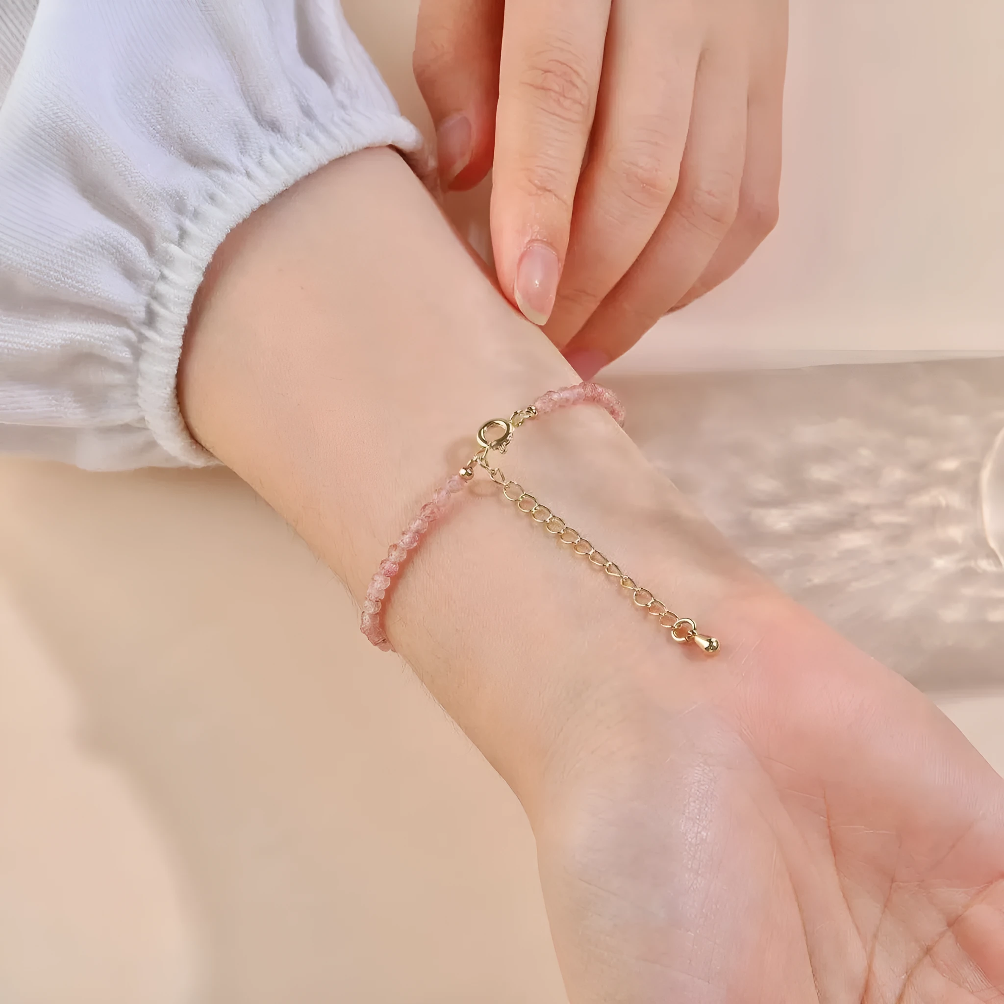 Natural strawberry quartz bracelet with 3mm polished diamond-cut beads on an adjustable cord