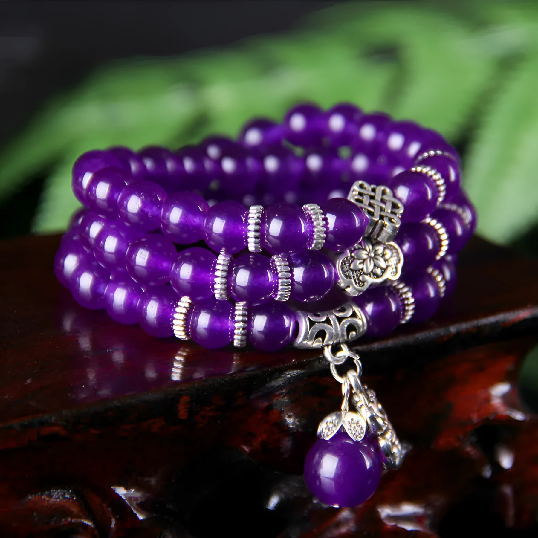 Purple ethnic-style women's bracelet with three circles of polished chalcedony beads on an adjustable band.