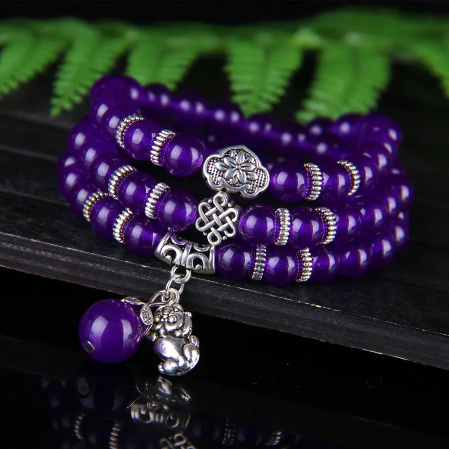 Purple ethnic-style women's bracelet with three circles of polished chalcedony beads on an adjustable band.