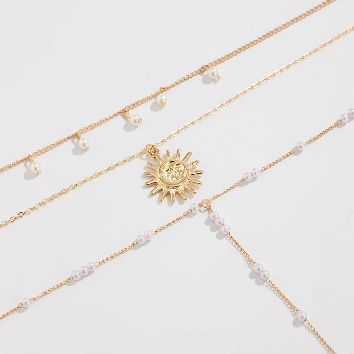 Long Y-shaped twin necklace with tassel pendant in gold electroplated alloy with imitation pearl chain