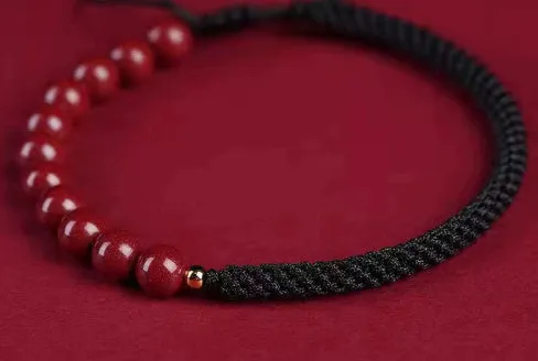 Braided rope bracelet with cinnabar beads in 8mm diameter and wine red colour