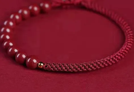 Braided rope bracelet with cinnabar beads in 8mm diameter and wine red colour