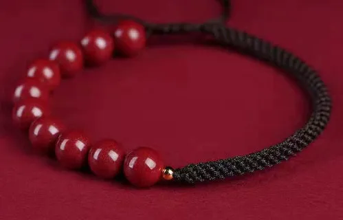 Braided rope bracelet with cinnabar beads in 8mm diameter and wine red colour