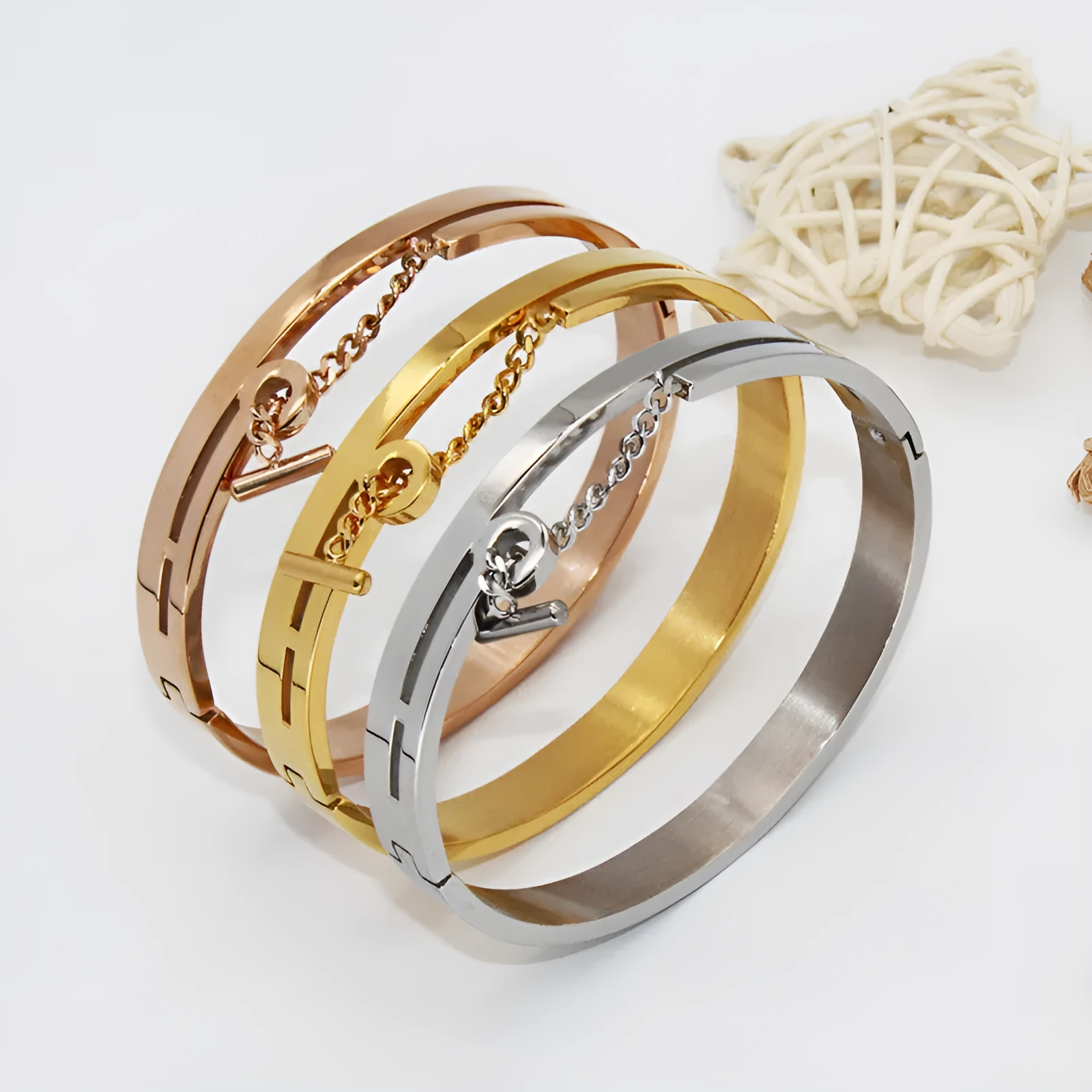 Geometric titanium steel bracelet in rose gold electroplated finish on white background