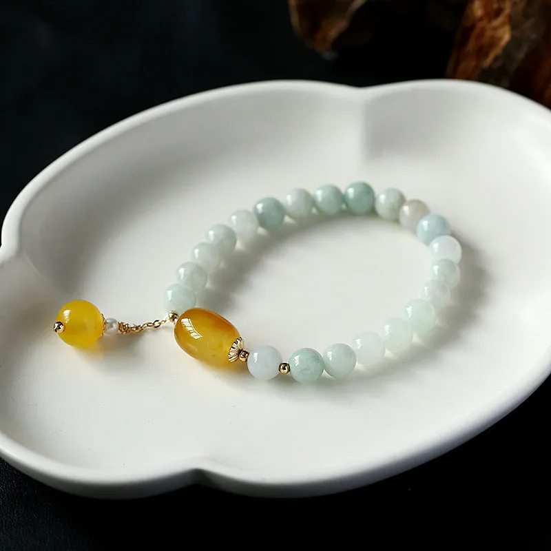 Women's ethnic style geometric bracelet with hanging agate tassel and 14K gilded details.