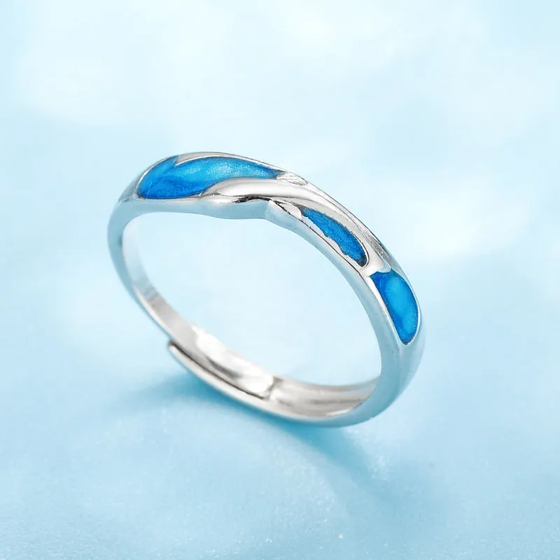 Silver adjustable couple ring with dolphin zodiac motif on white background