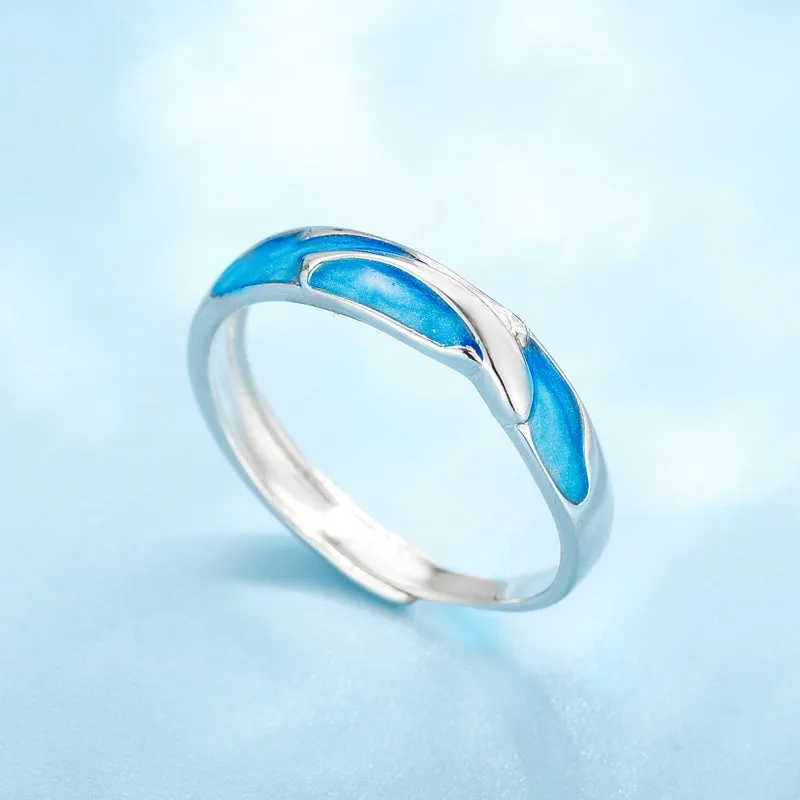 Silver adjustable couple ring with dolphin zodiac motif on white background