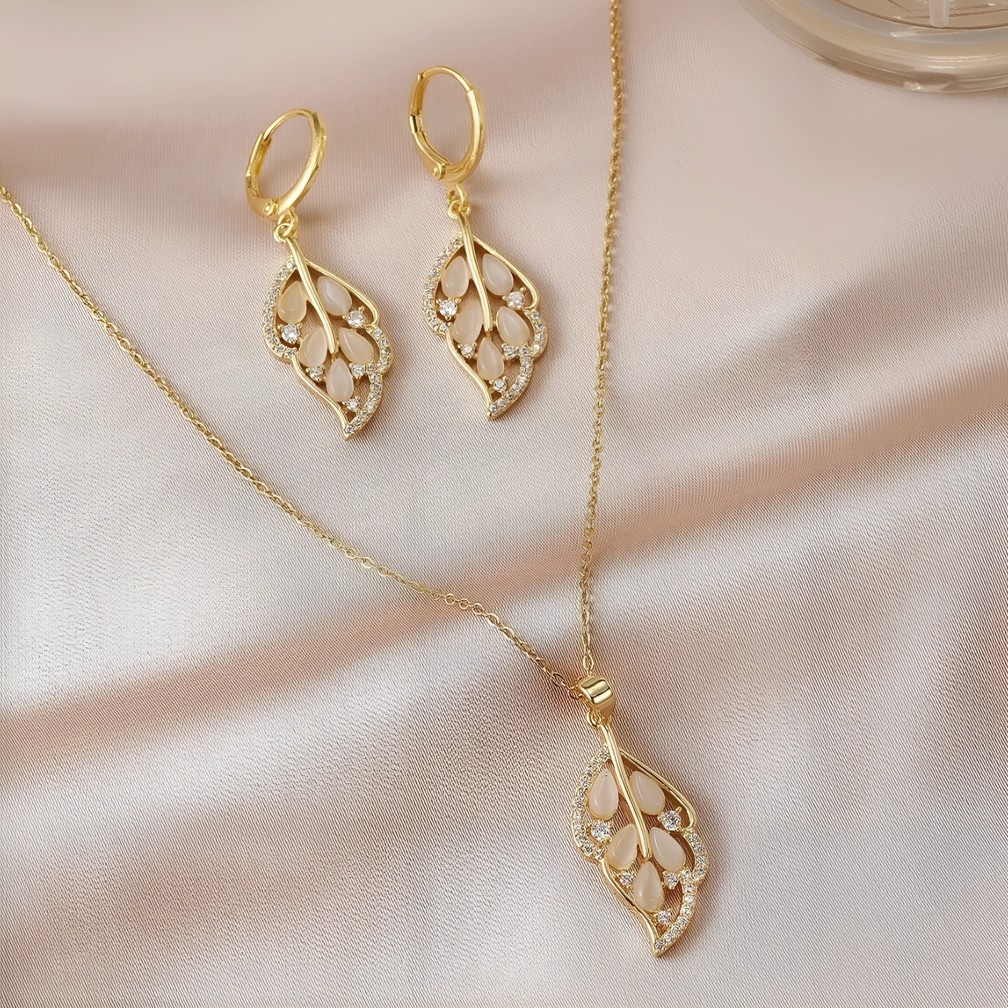 Opal leaves copper electroplated necklace and earrings set on display