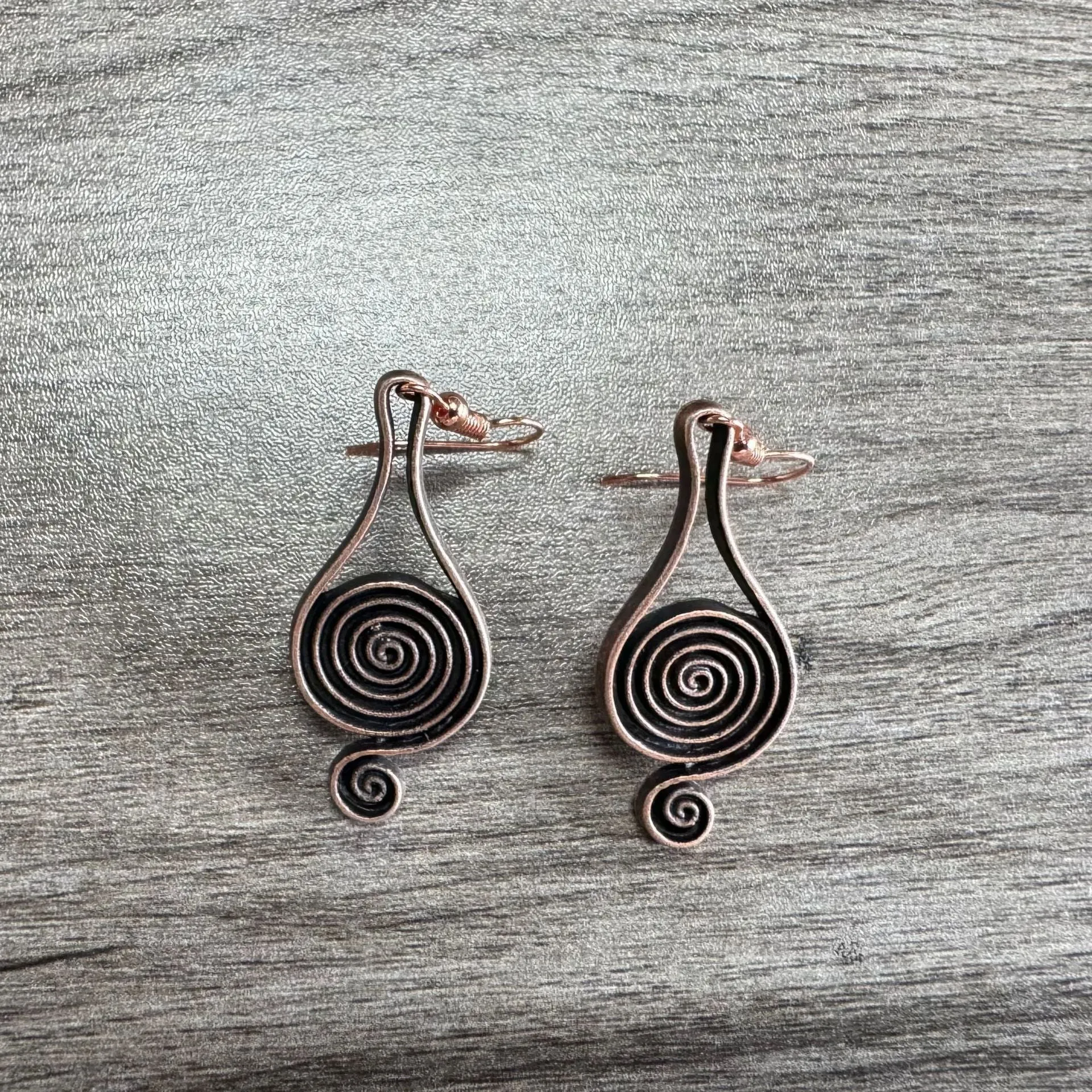 Bronze spiral psychedelic drop earrings with geometric shape and alloy construction