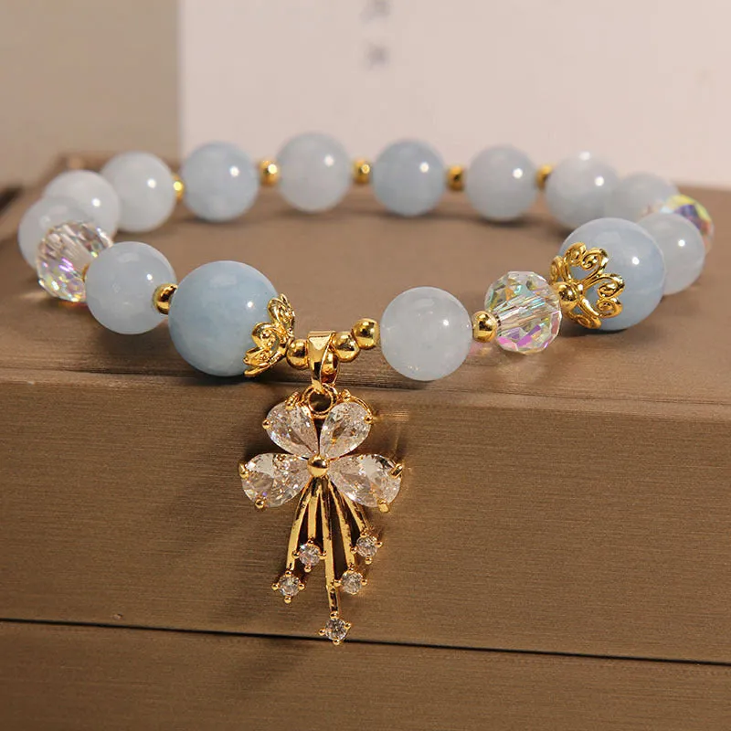Normcore style crystal bracelet with amethyst and pearl charms on adjustable closure